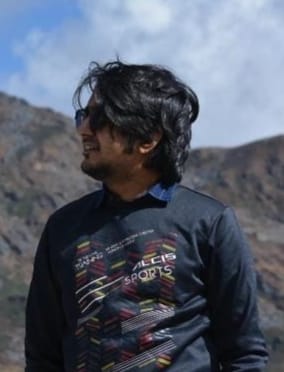 Srijan Roy Sir against a mountain backdrop